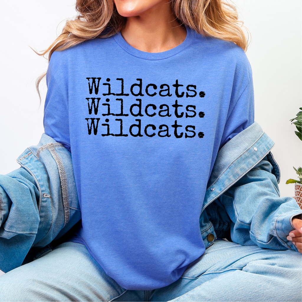 Person wearing a blue sweatshirt with 'Wildcats. Wildcats. Wildcats.' text.