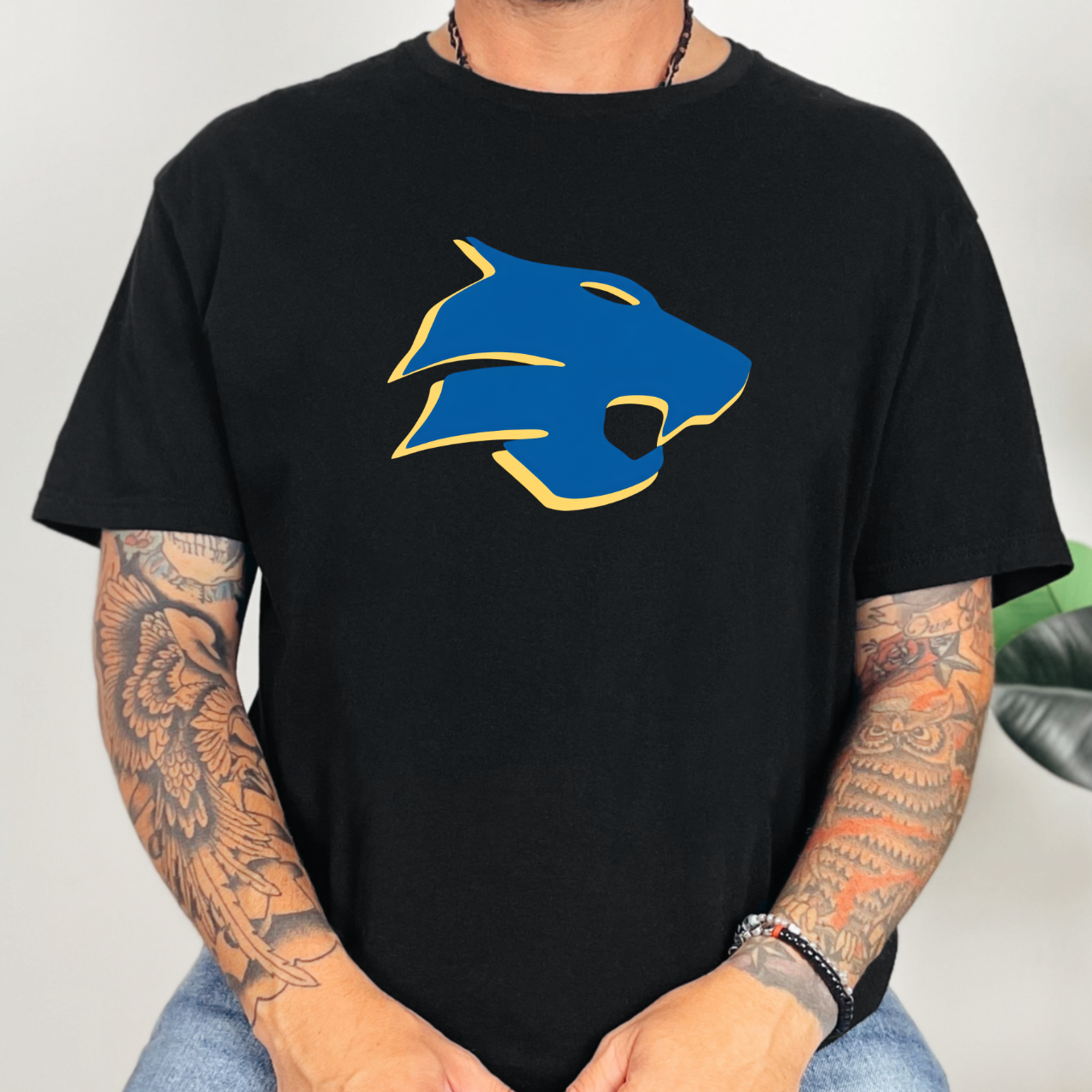Person wearing a black t-shirt with a blue and yellow Durant Wildcats logo. 
