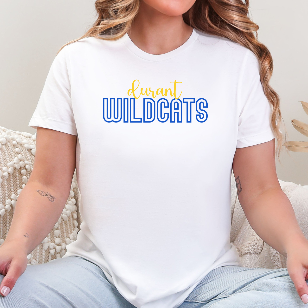 Person wearing a white t-shirt with 'durant WILDCATS' text