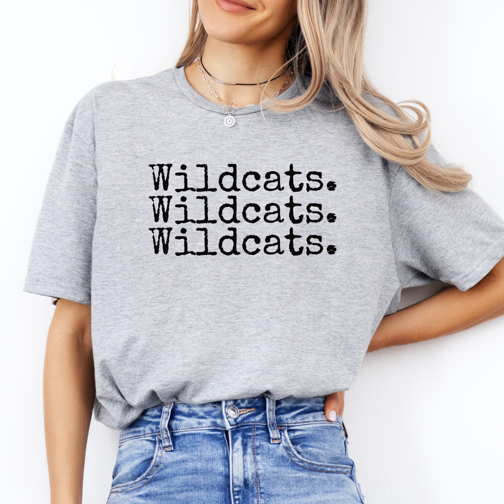Person wearing a gray t-shirt with 'Wildcats. Wildcats. Wildcats.' text on a white background