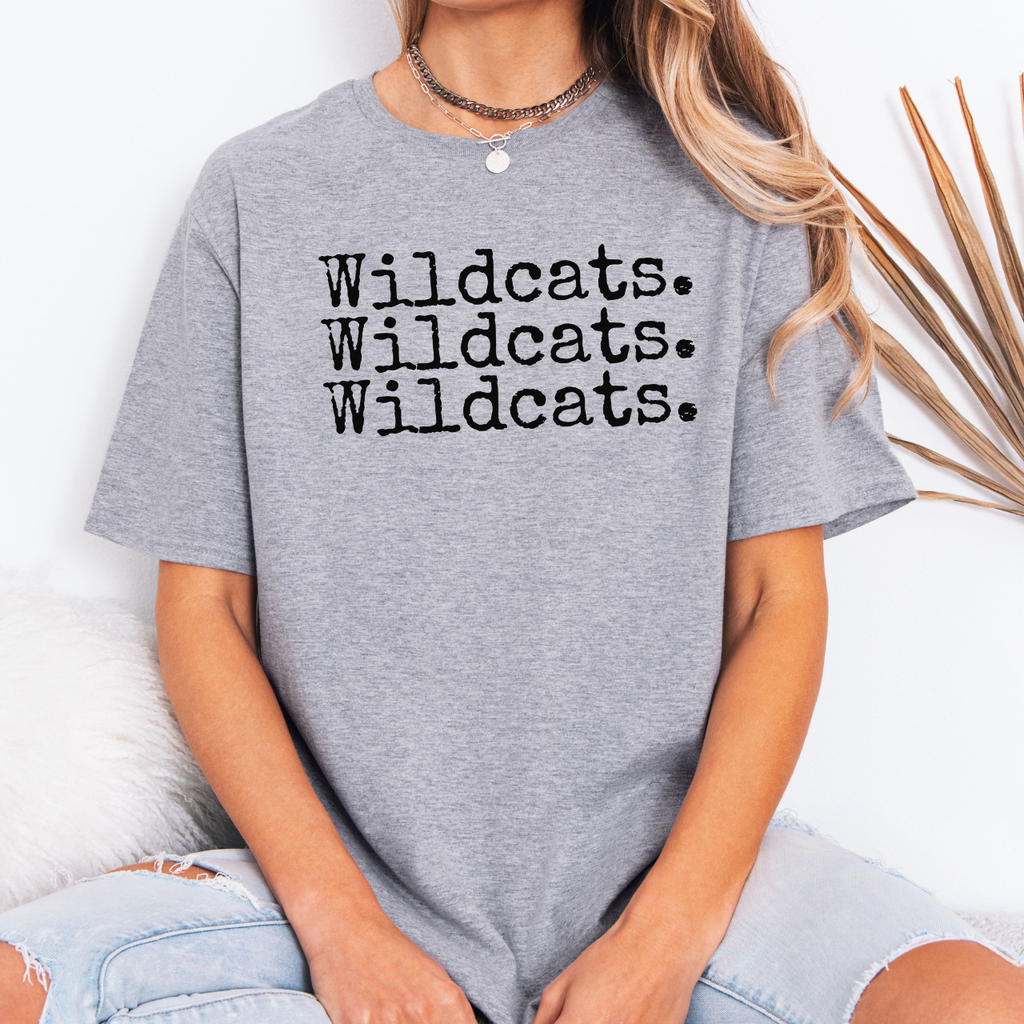 Person wearing a gray t-shirt with 'Wildcats. Wildcats. Wildcats.' text.